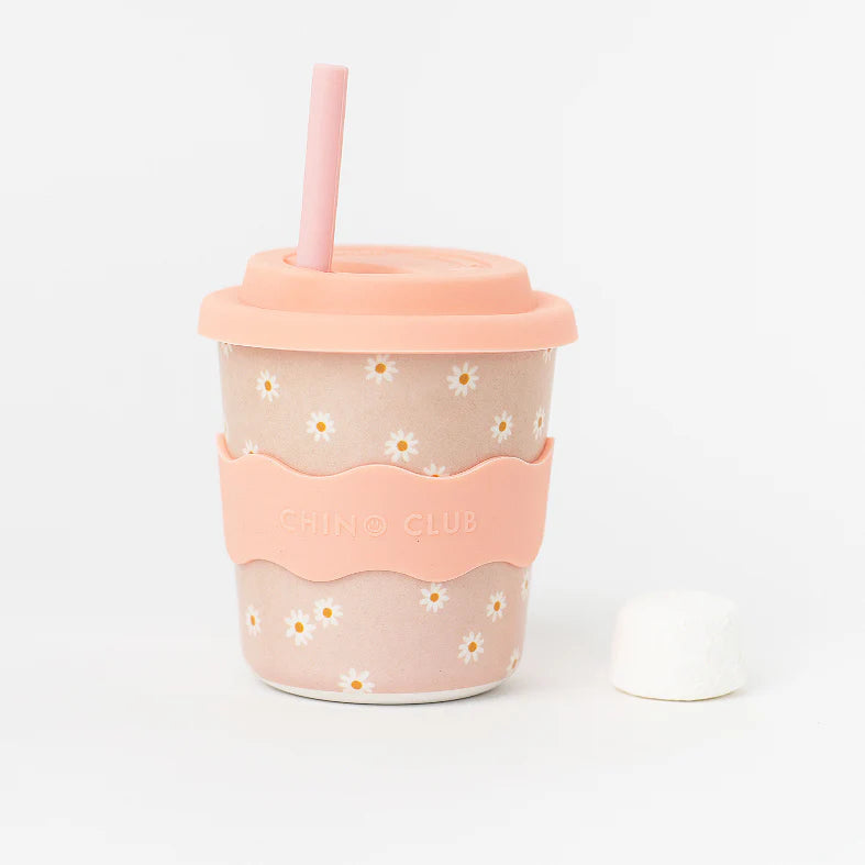 Pink daisy keep cup with silicone lid, straw, and CHINO CLUB branding