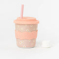 Pink daisy keep cup with silicone lid, straw, and CHINO CLUB branding