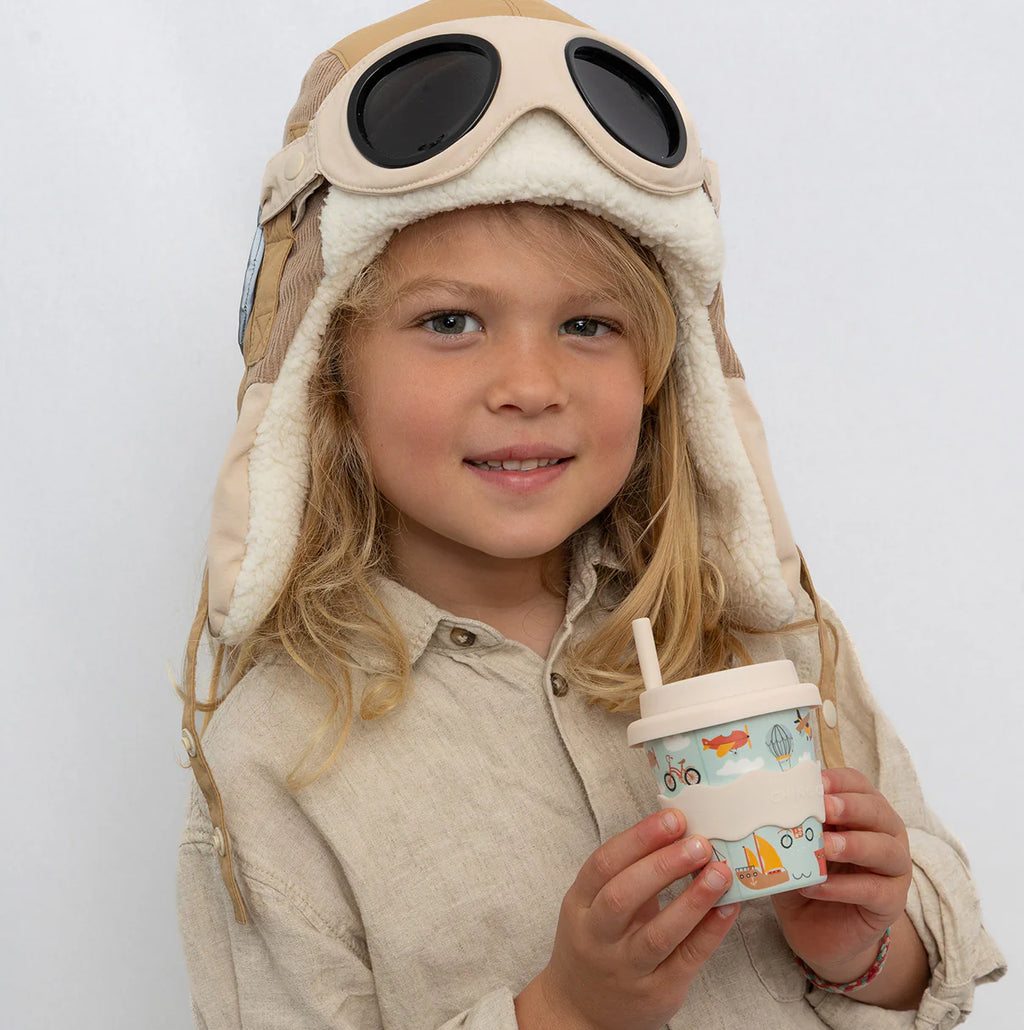 Babychino cup with lid and vehicles print, child holding cup with straw